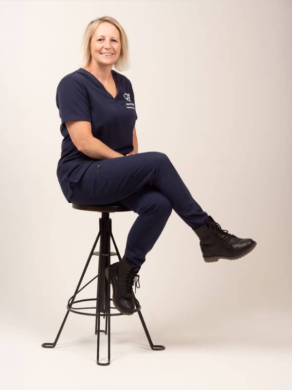 Nurse Tutor Hannah sat on a stool